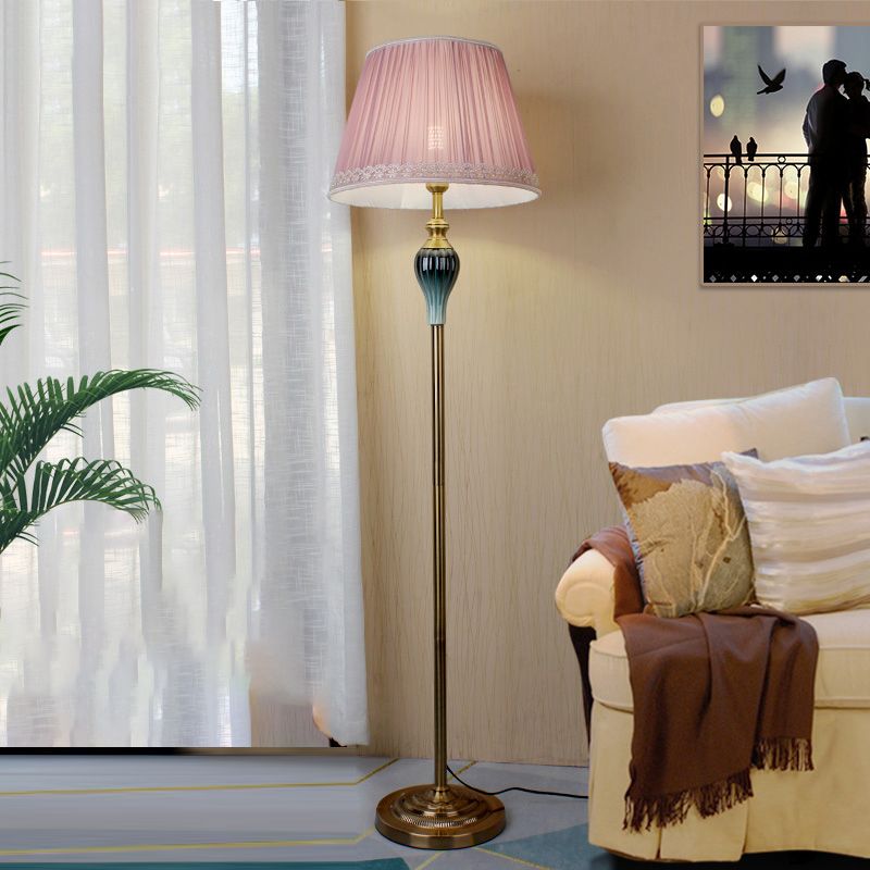Pink retro pleated fabric floor lamp providing warm ambient lighting in a bedroom or lounge