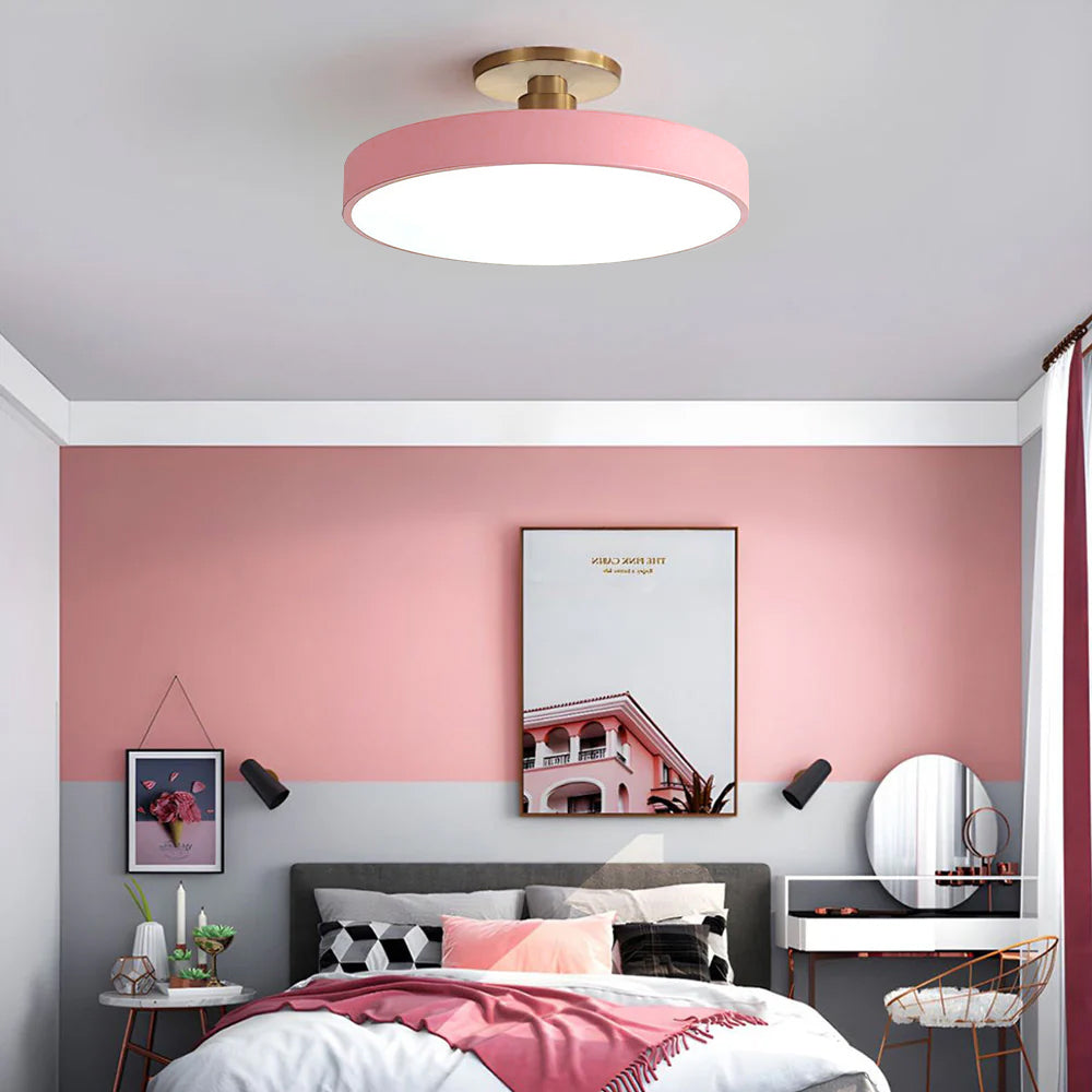 Pink round LED ceiling fixture enhancing a beautifully styled pink and grey bedroom