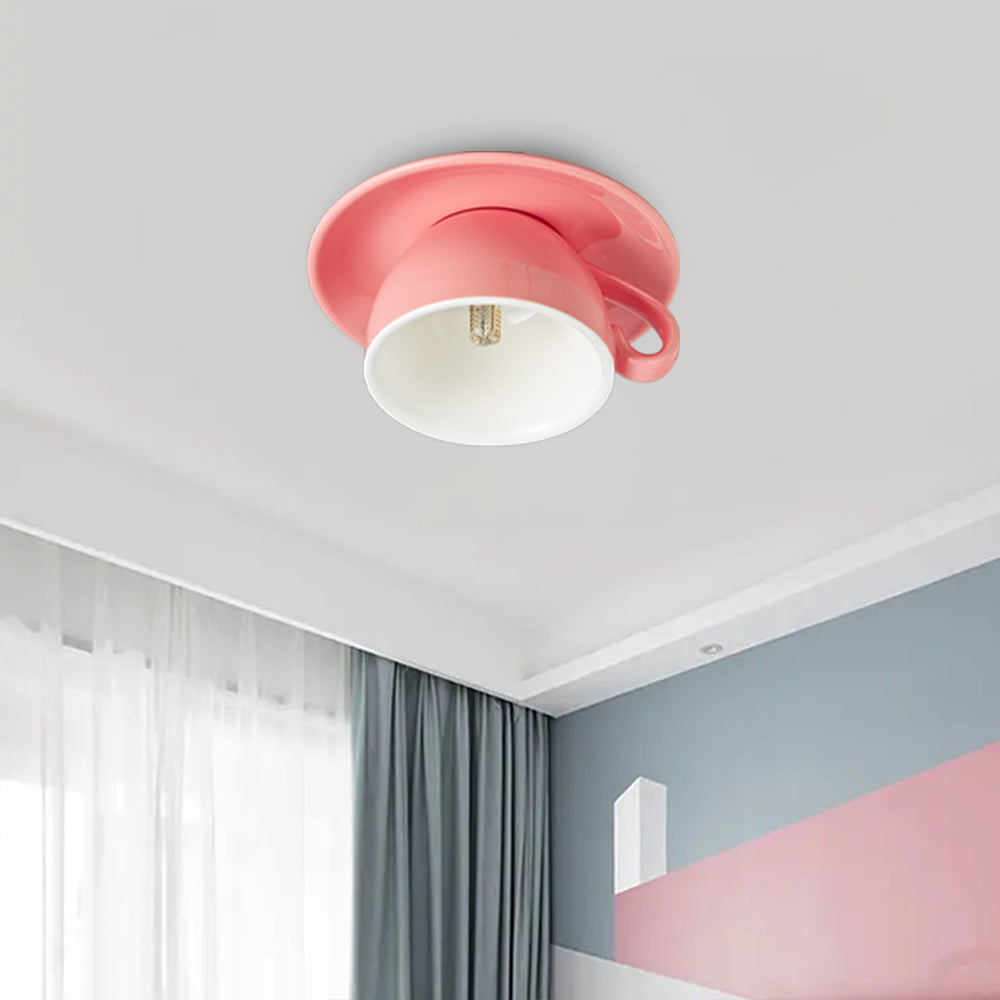 Pink ceramic teacup ceiling light adding a whimsical, colourful touch to a modern bedroom