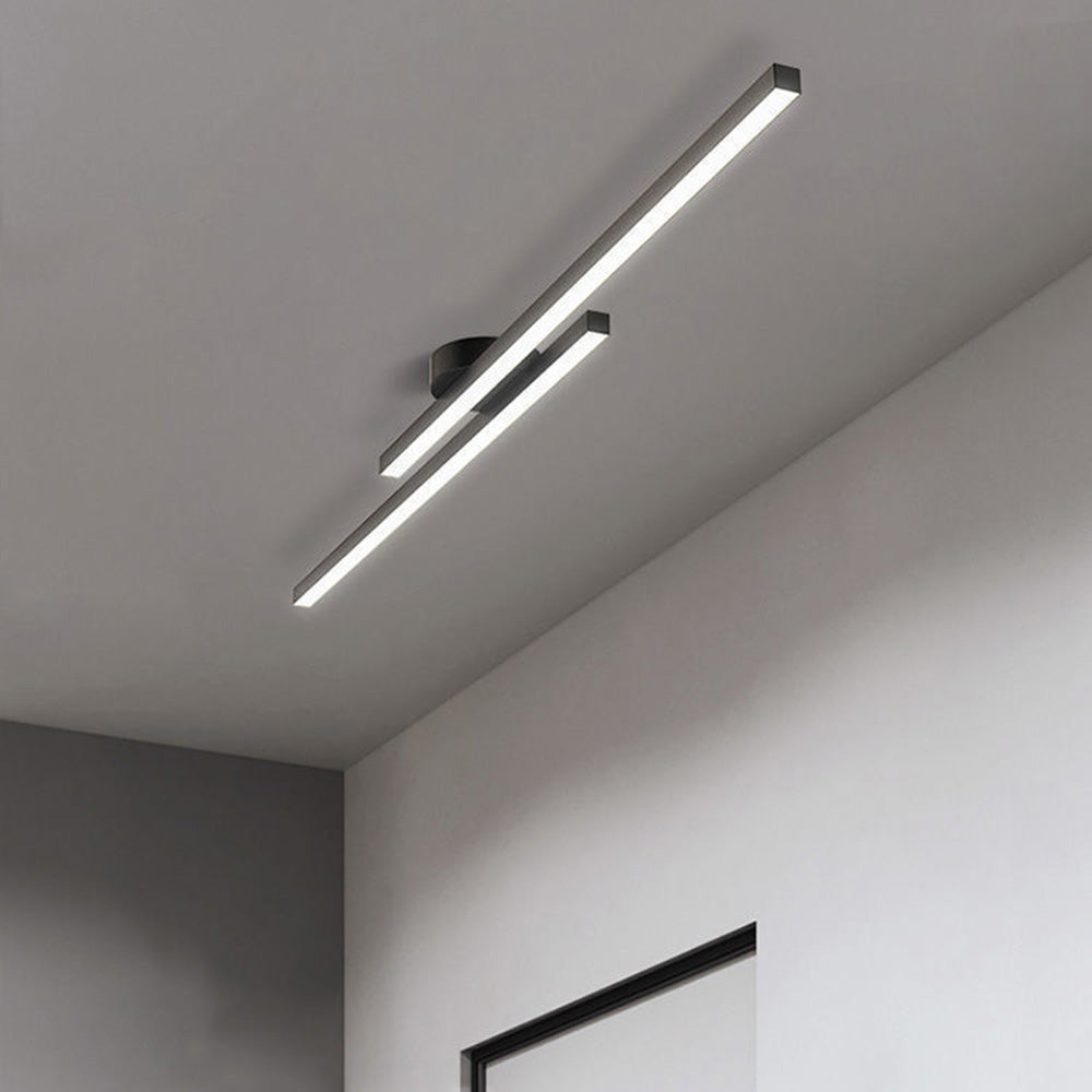 Modern black staggered linear LED semi-flush mount poxu ceiling light installed in a minimalist room