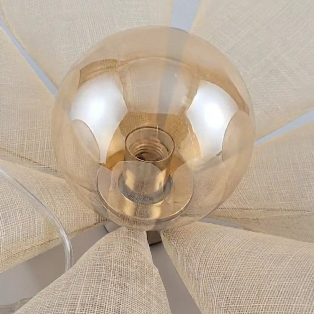 Upward view into the lit Puvzo rattan lotus pendant light shade showing the glass globe