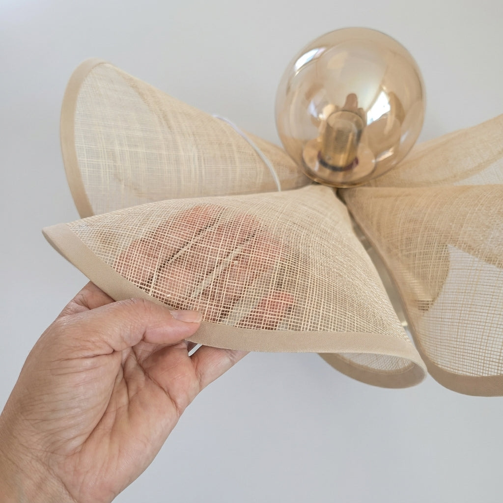 Close-up of a woven rattan petal from the Puvzo pendant light shade