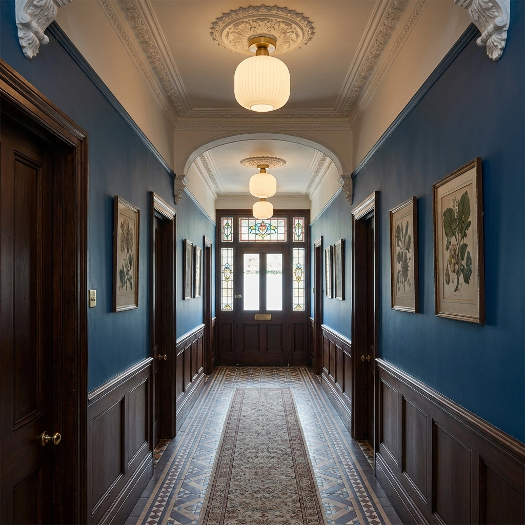 Qavlu ceiling lights installed along a hallway with artwork and dark blue walls