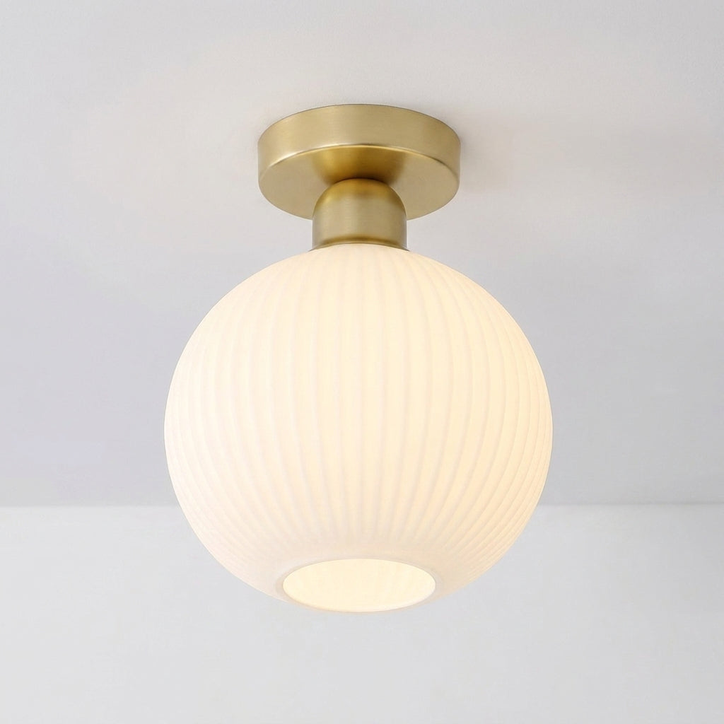 Qavlu ceiling light with a round glass shade illuminated, on white background