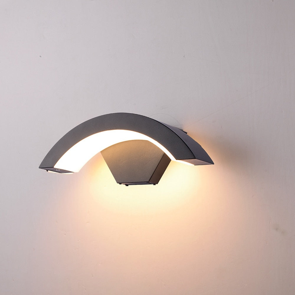 Sleek black arched qaxo LED wall light isolated on a clean, plain background