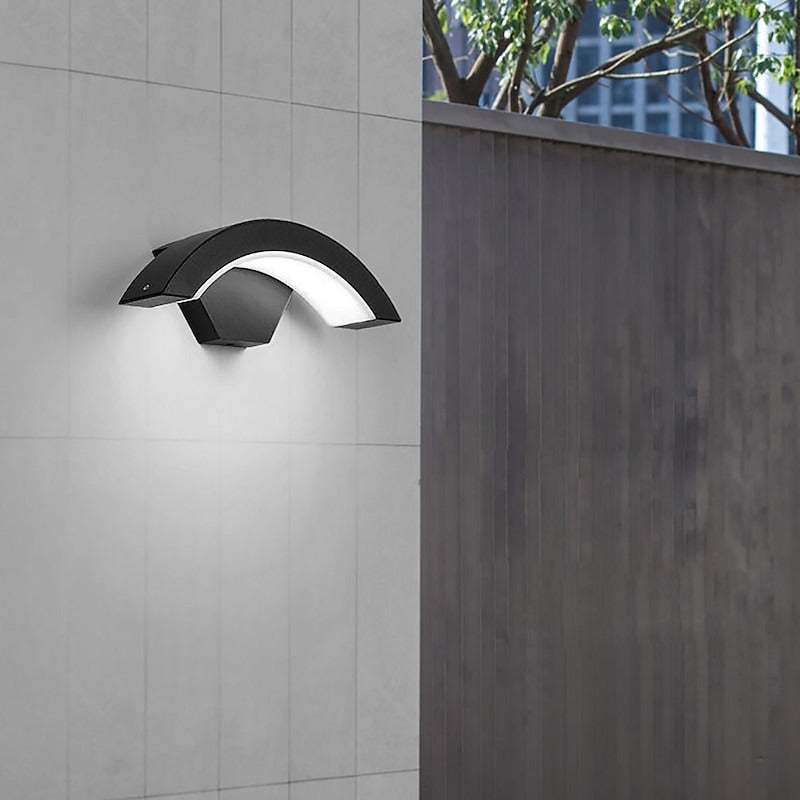 Minimalist black qaxo crescent outdoor wall lamp installed on a modern grey exterior fence