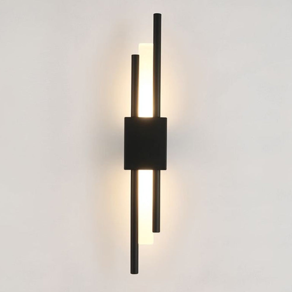 Modern black staggered linear LED qytu wall sconce mounted vertically on a light wall