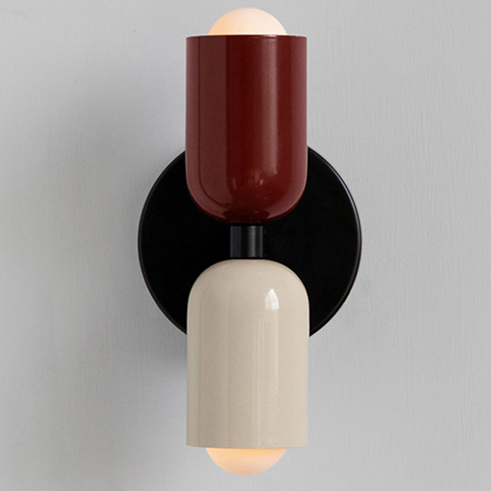 Red and beige mid-century wall light featuring two glowing capsule shades