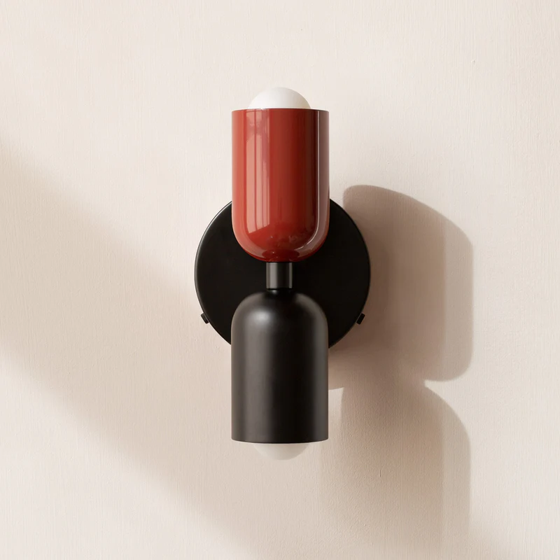 Red and black double glass wall sconce offering a bold contemporary contrast