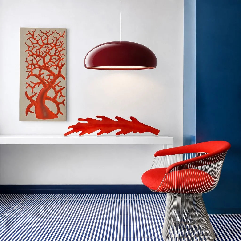 Vibrant red Bauhaus pendant light acting as a striking focal point in a colourful modern interior