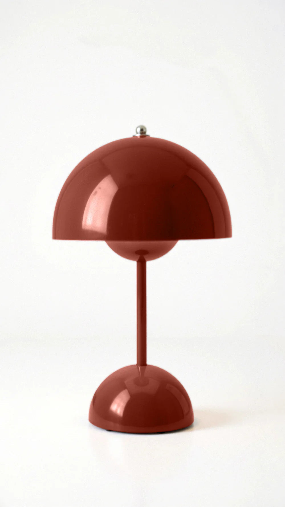 Vibrant red cordless mushroom table lamp isolated on a clean white background