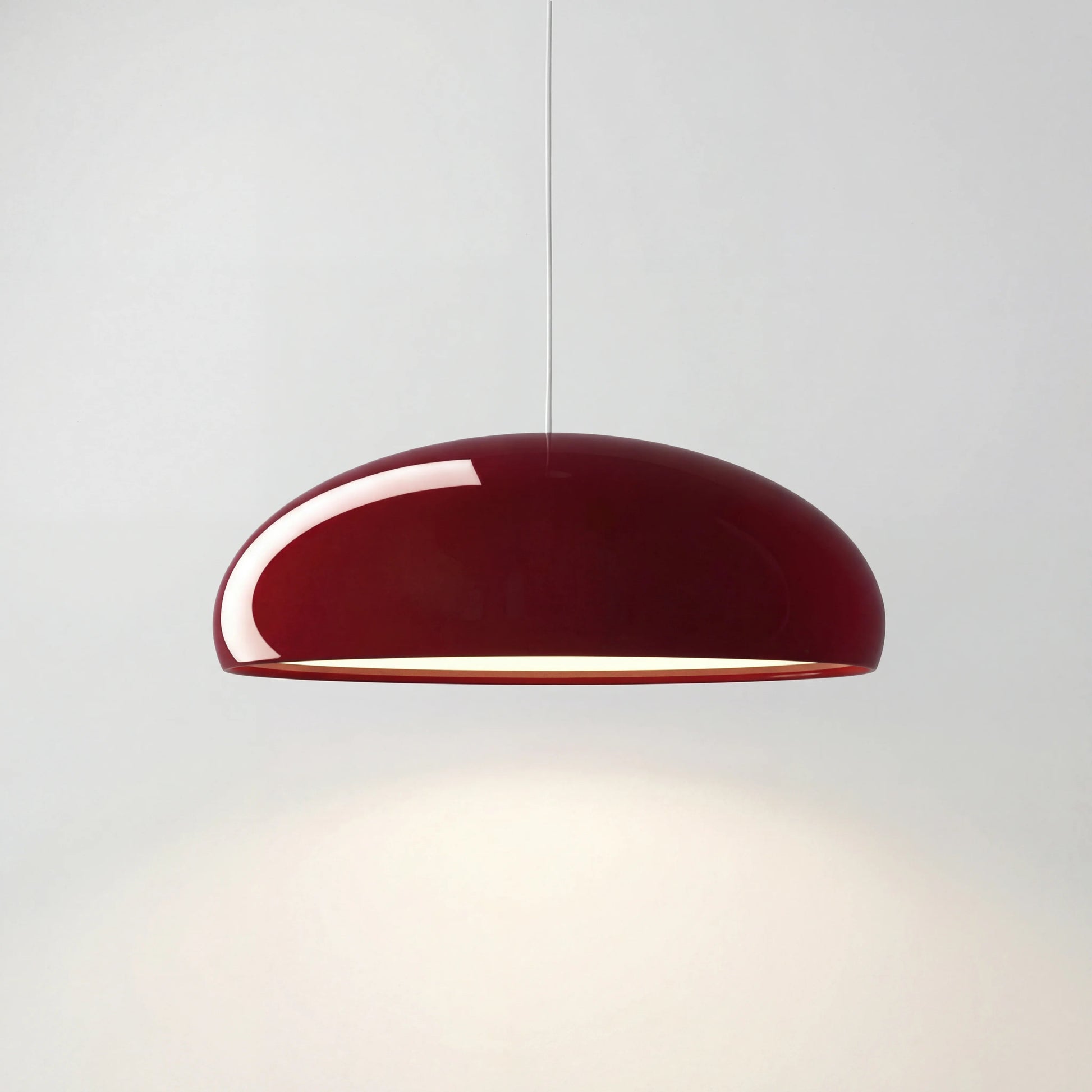 Deep red Nordic acrylic bowl pendant lamp isolated on a clean white background