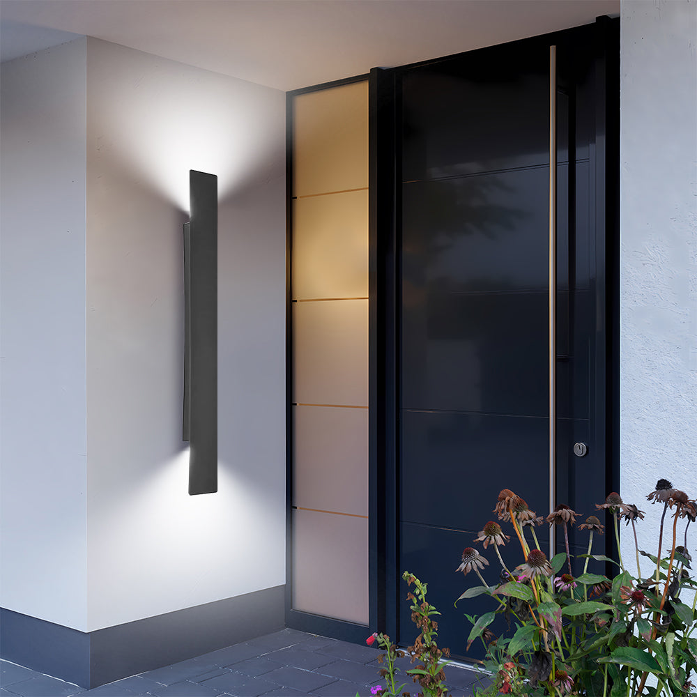 Black rectangular reta outdoor sconce installed beside a contemporary frosted glass front door
