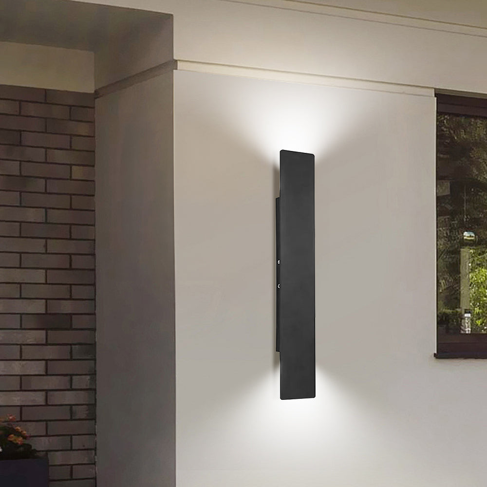 reta black outdoor LED sconce providing elegant lighting above a wooden house number plaque