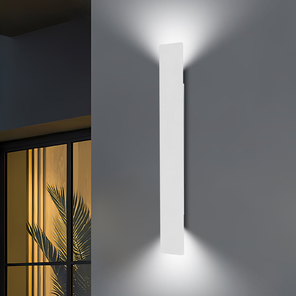White slim reta LED wall light providing striking contrast on a dark grey exterior wall