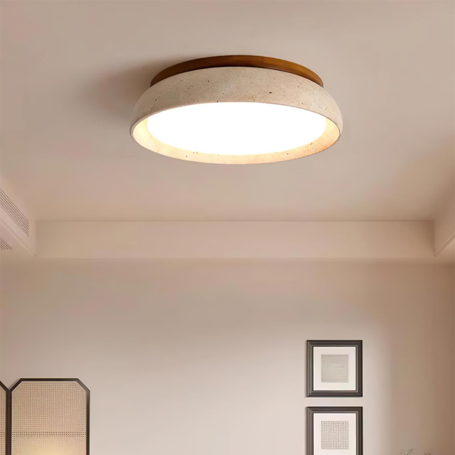 Round travertine ceiling fixture in a serene Japandi style living room
