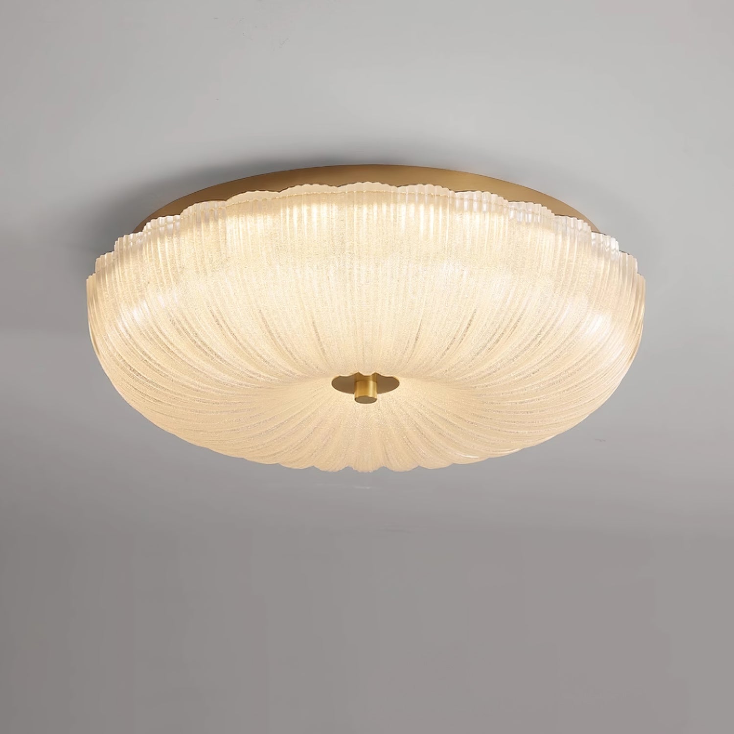 Close-up of the modern ripple glass flush mount rutyl ceiling light glowing warmly