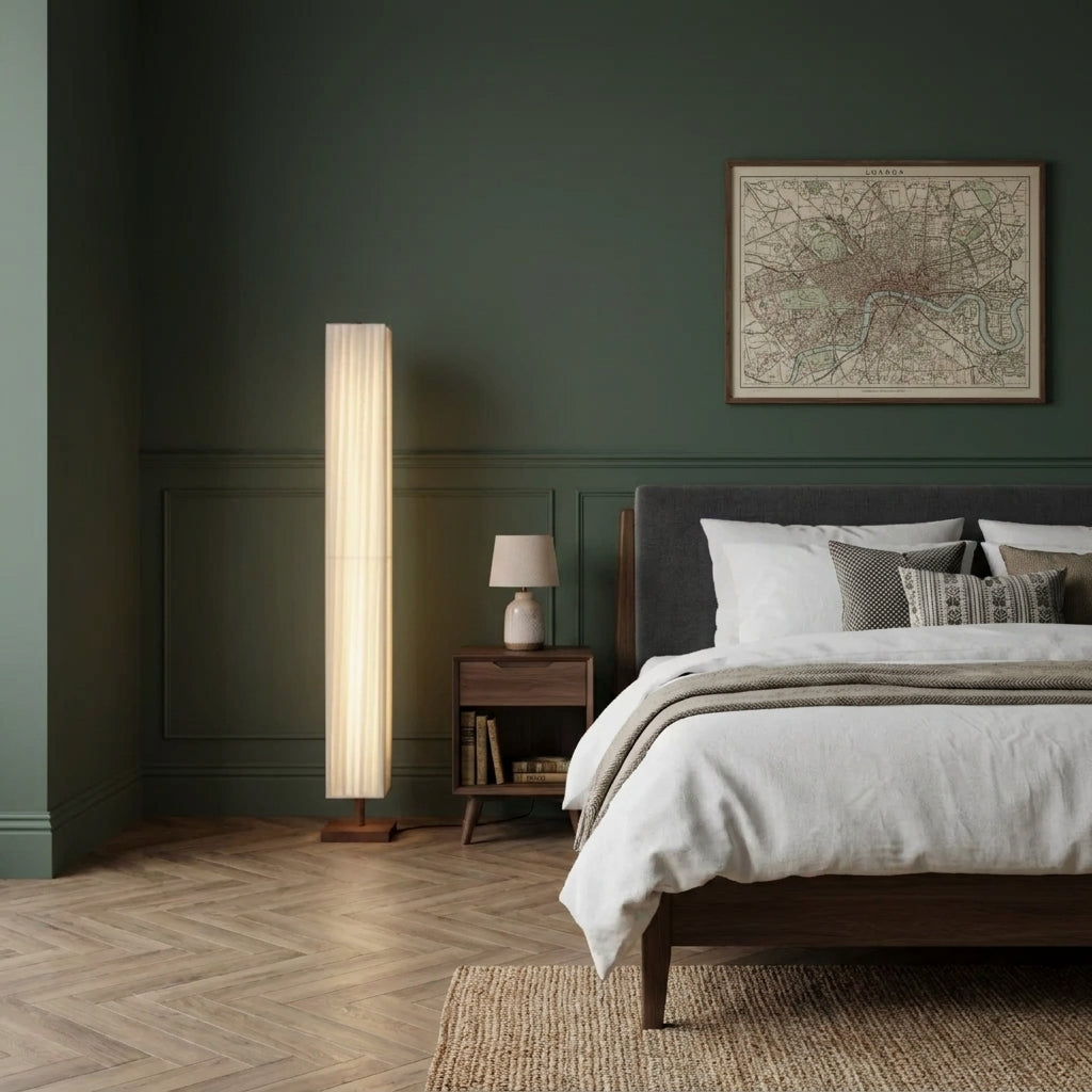 Ruxpa walnut floor lamp beside a wood bed frame and nightstand in a green-toned bedroom with a framed vintage map