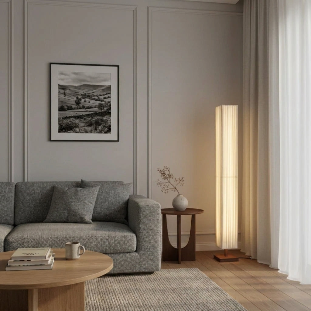 Ruxpa walnut floor lamp in a living room with a grey sofa and framed landscape art