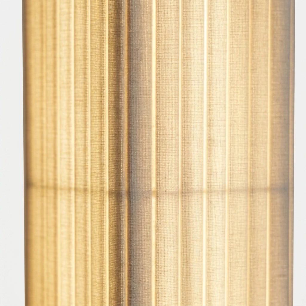 Close-up of the Ruxpa lamp's pleated fabric shade glowing warm white