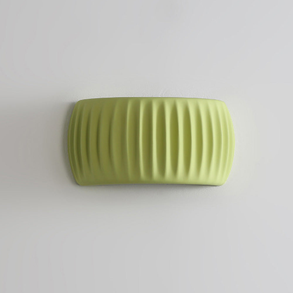 Modern green ryfy fluted resin wall sconce isolated against a clean white background