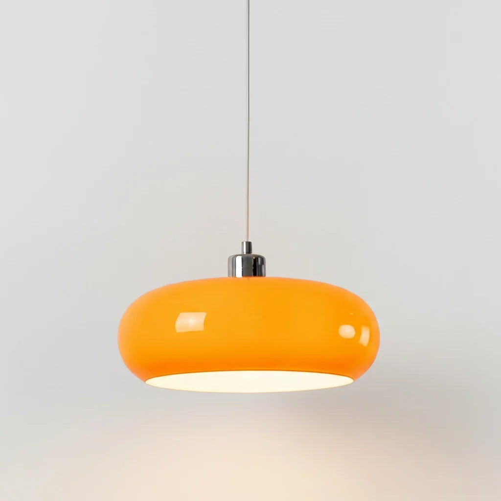 Bright orange Bauhaus seqa glass ceiling lamp glowing warmly against a light, neutral background