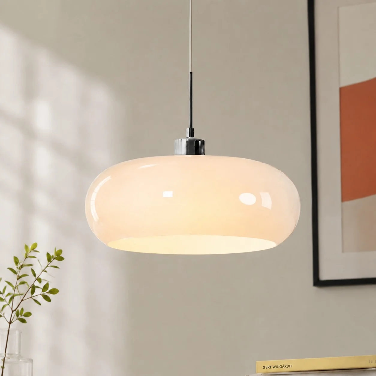 Modern seqa white hand-blown glass dome pendant light hanging gracefully in a minimalist living space