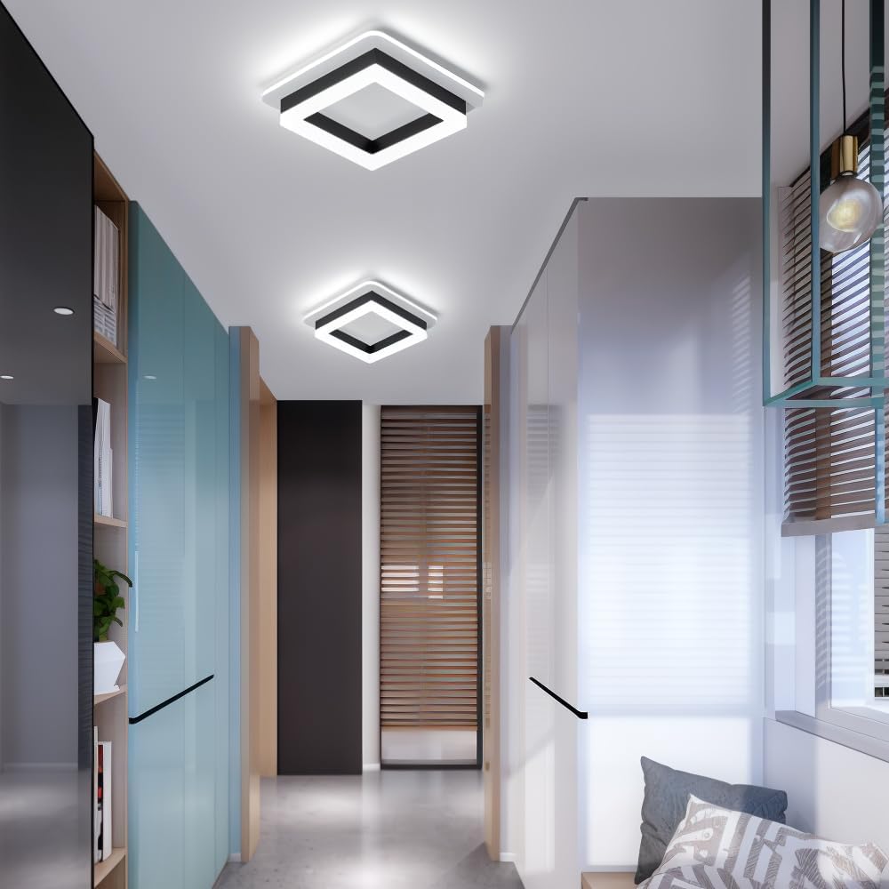 Two modern black square LED flush mount serq ceiling lights in a bright contemporary glass corridor