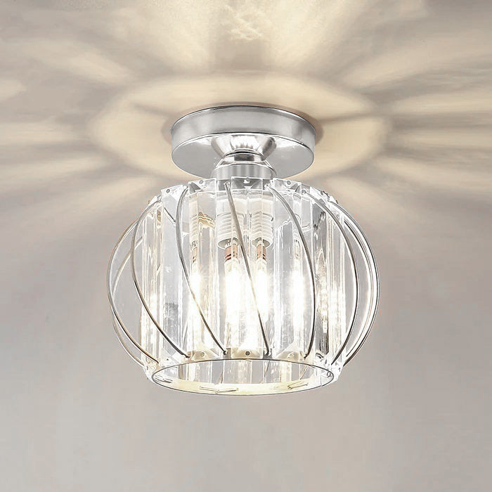 Sleek silver crystal globe ceiling light illuminated to show a brilliant starburst reflection on the ceiling