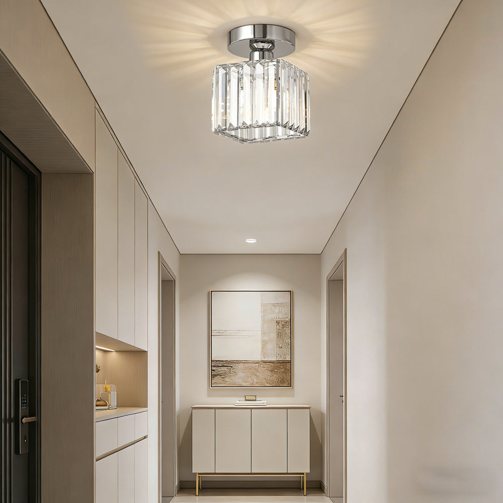 Silver crystal prism ceiling light installed in a clean, minimalist white hallway