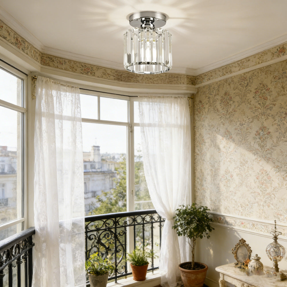 Silver round crystal ceiling lamp illuminating a classic dining and living area