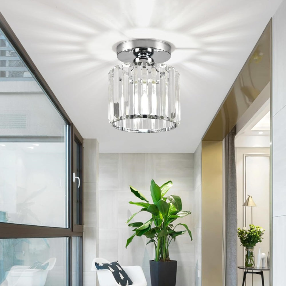 Silver round crystal ceiling lamp installed in a modern, naturally lit living room