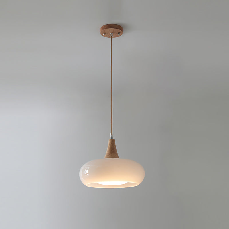 Single white Nordic glass and wood dome pendant isolated against a light grey wall