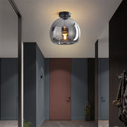 Modern smoke grey retro glass globe flush mount ceiling light illuminating a contemporary entryway