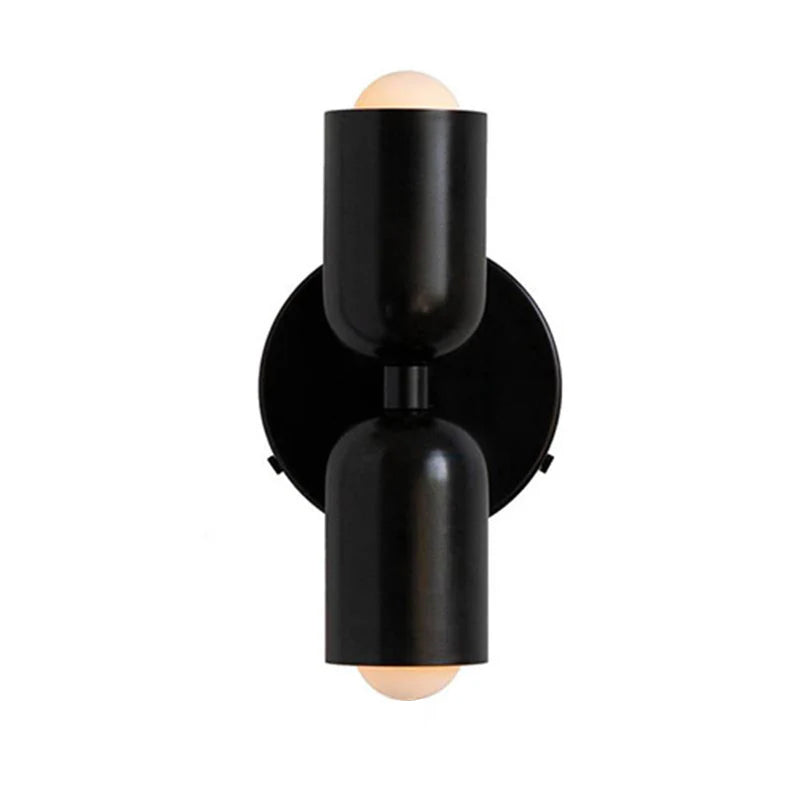 Solid black capsule glass wall sconce for a sleek, monochromatic modern look