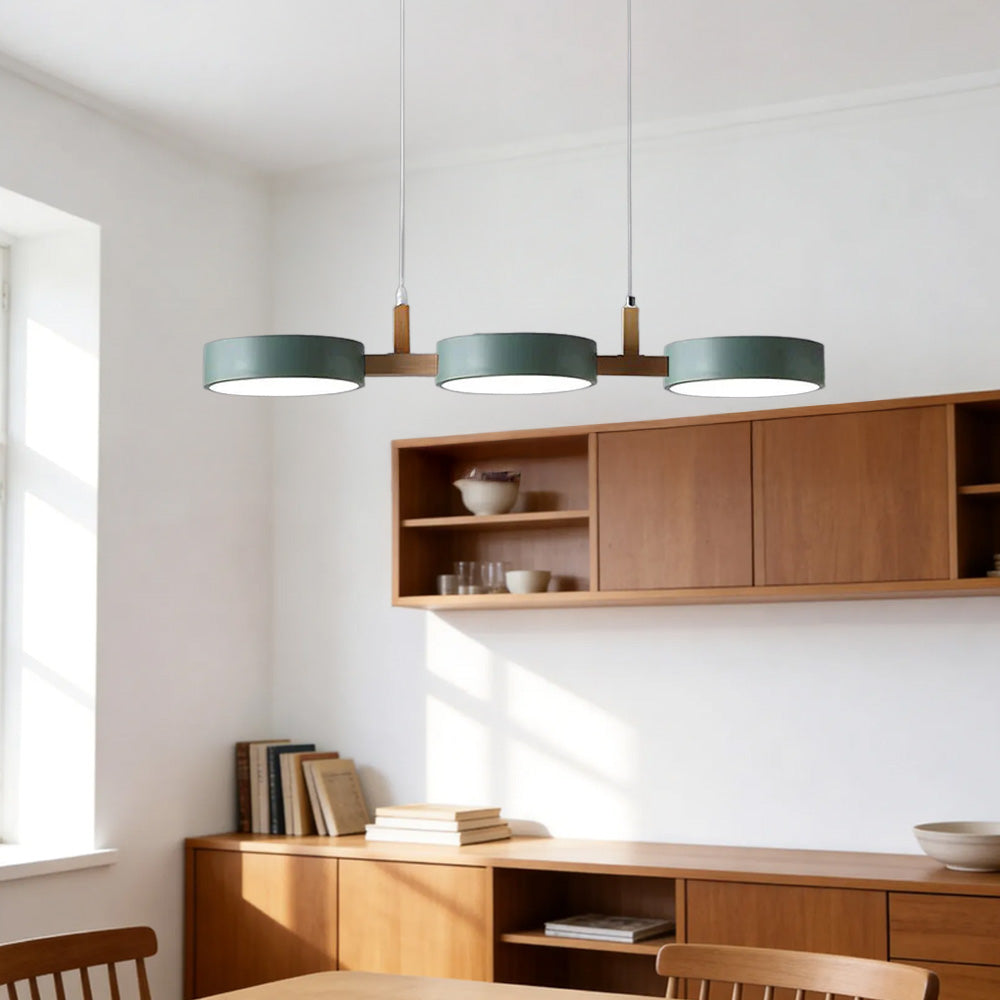 Solid green wood and metal linear pendant illuminating a bright modern kitchen island
