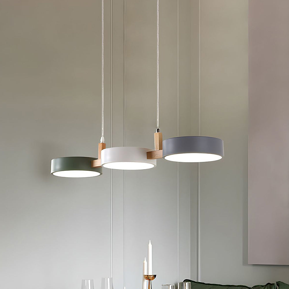 Solid 3-light linear pendant lamp suspended in a modern kitchen.