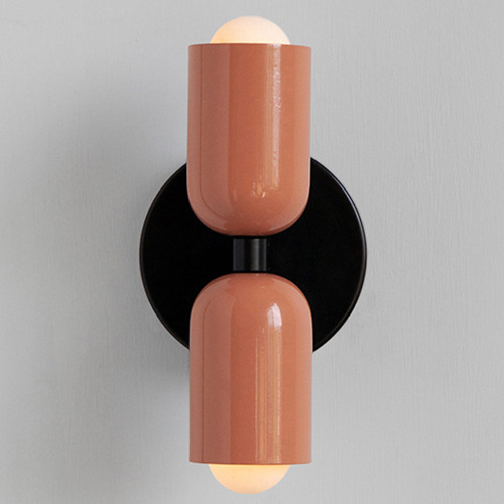 Solid pink retro glass wall lamp with a sleek black central wall bracket