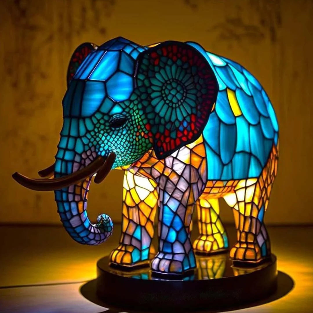 Stained glass effect elephant nightlight glowing brightly against a dark background