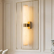 Subxo LED linear marble wall sconce in Brass mounted on a ribbed wall panel