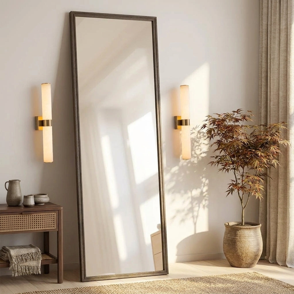 Subxo Brass wall sconce mounted beside a full-length mirror