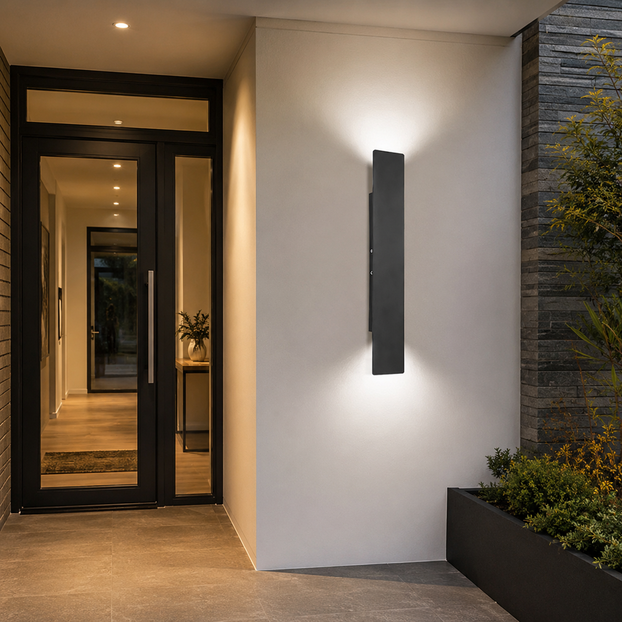 Tall black LED wall light installed next to a modern residential front door