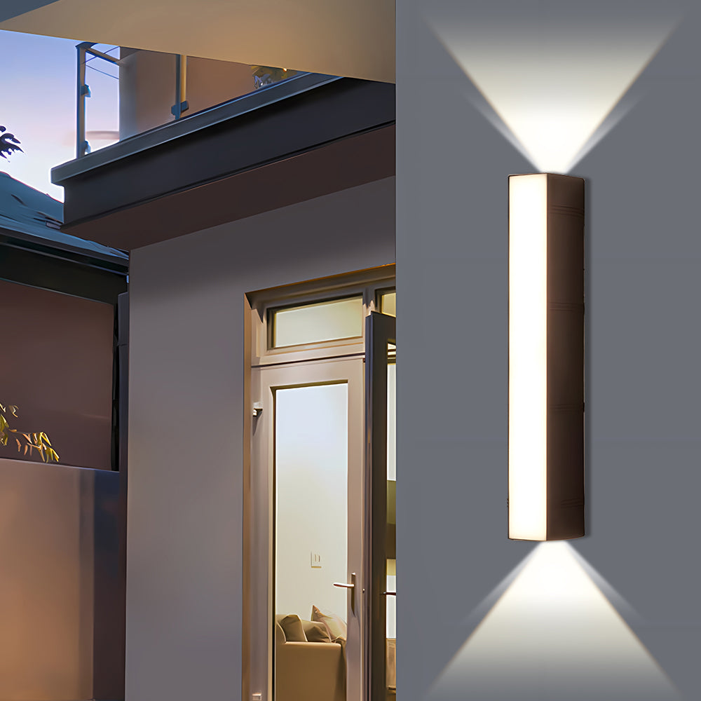 Tall exterior LED sconce illuminating the architectural pillar between two glass patio doors at twilight