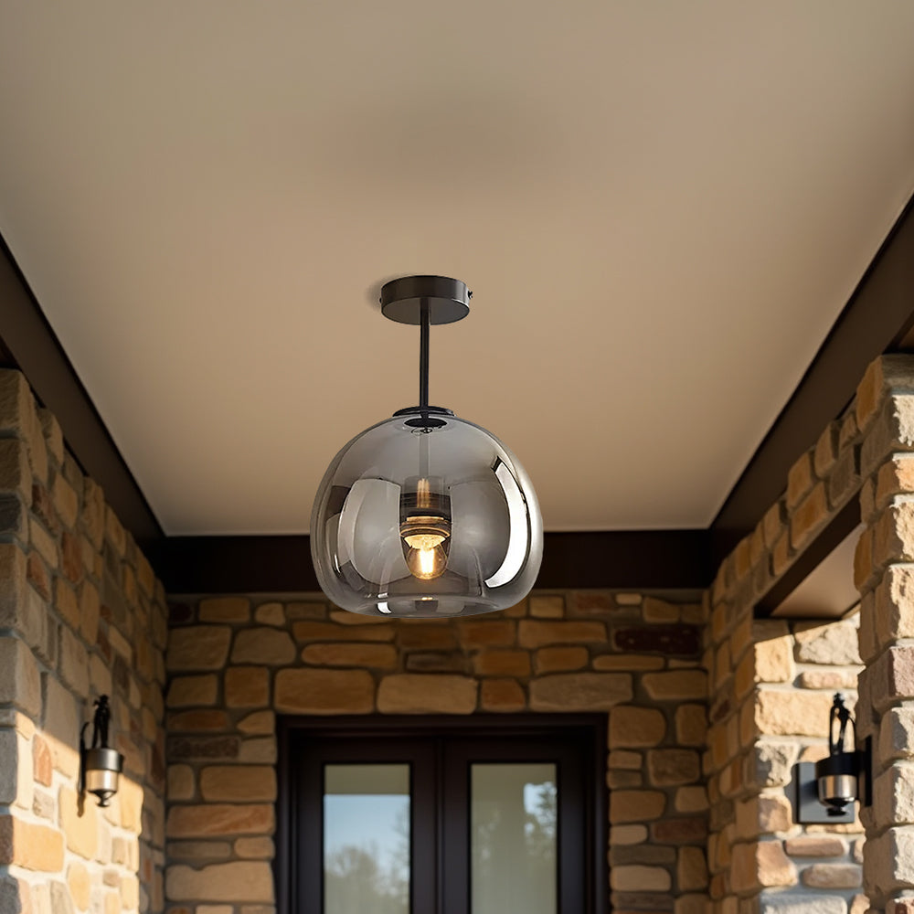 Tall smoke grey glass dome ceiling light providing ambient illumination on a covered porch entryway
