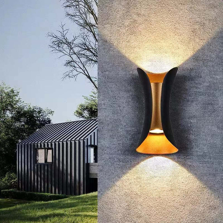 teka IP65 waterproof outdoor wall light highlighting a textured exterior wall and garden space