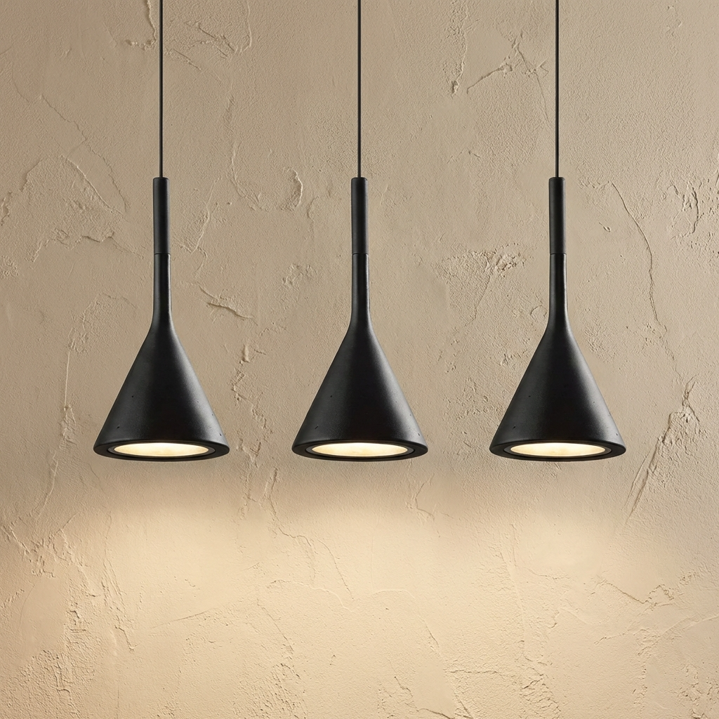 Cluster of three black minimalist teardrop resin ters pendant lights suspended in a row