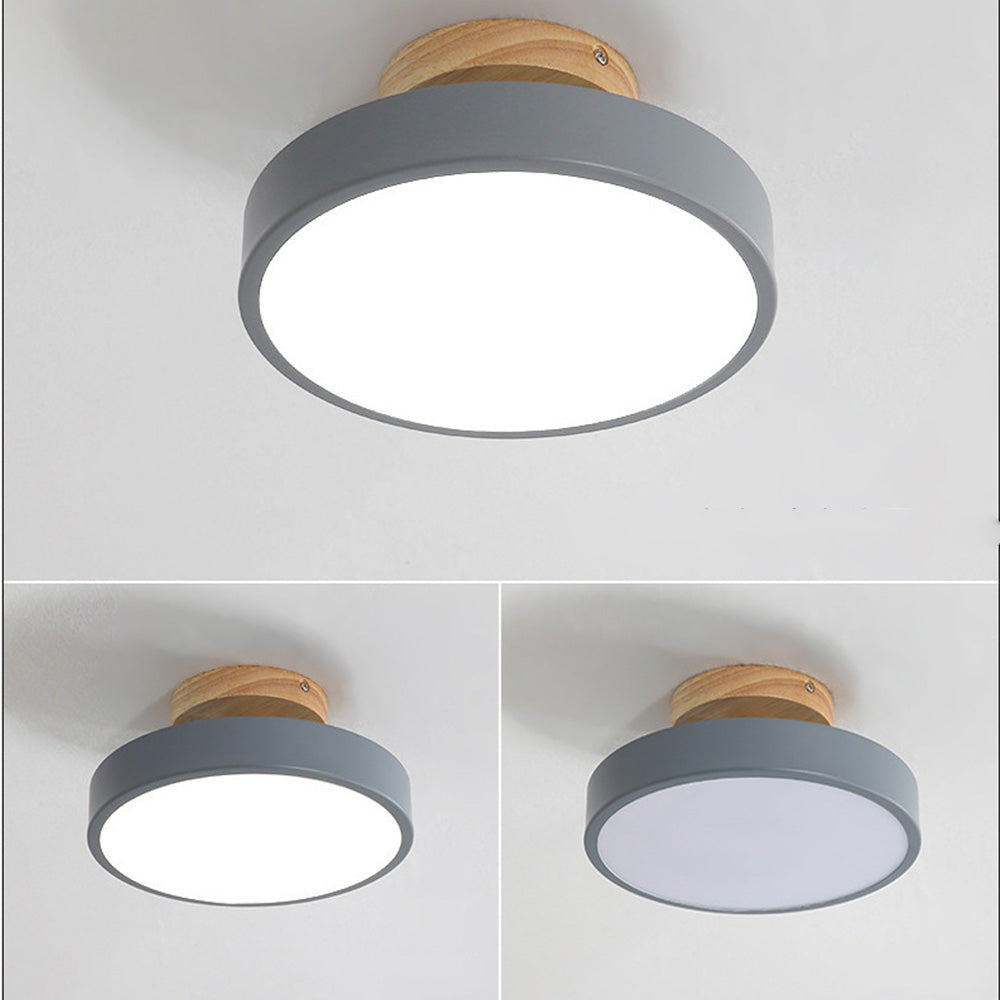 Three grey and wood semi flush mount ceiling lights installed on a clean white ceiling