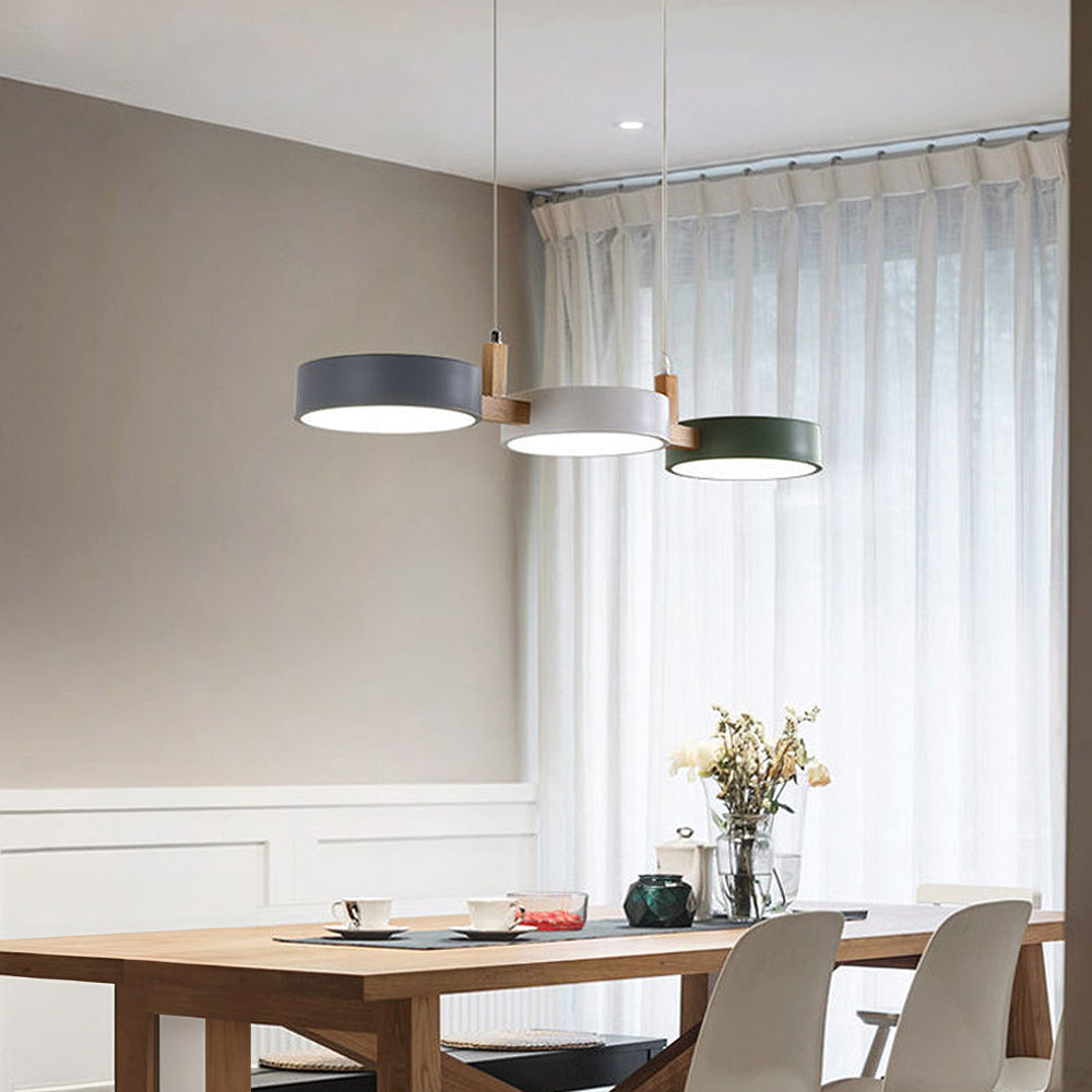Three-head drum chandelier acting as an elegant focal point in a dining space