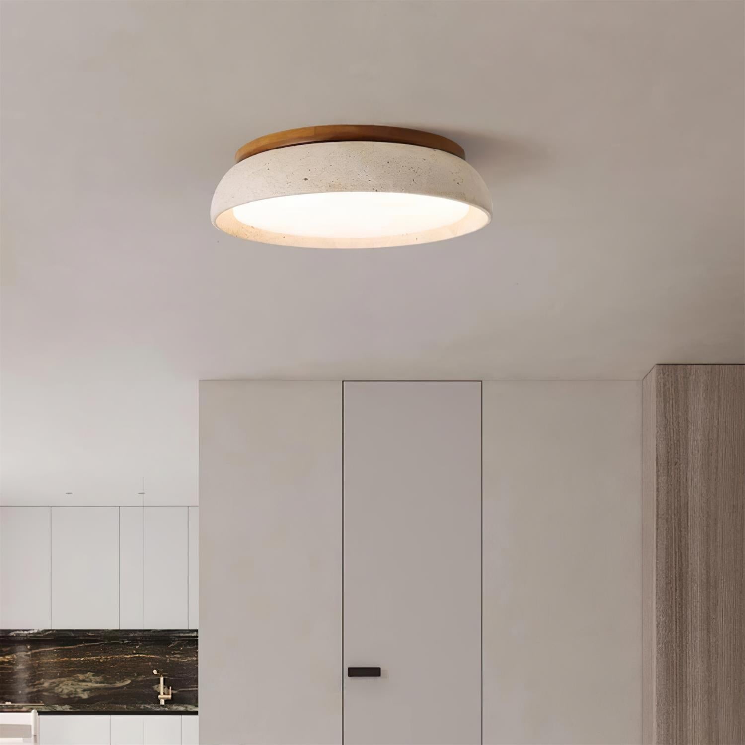 Travertine flush mount ceiling light illuminating a bright modern living space