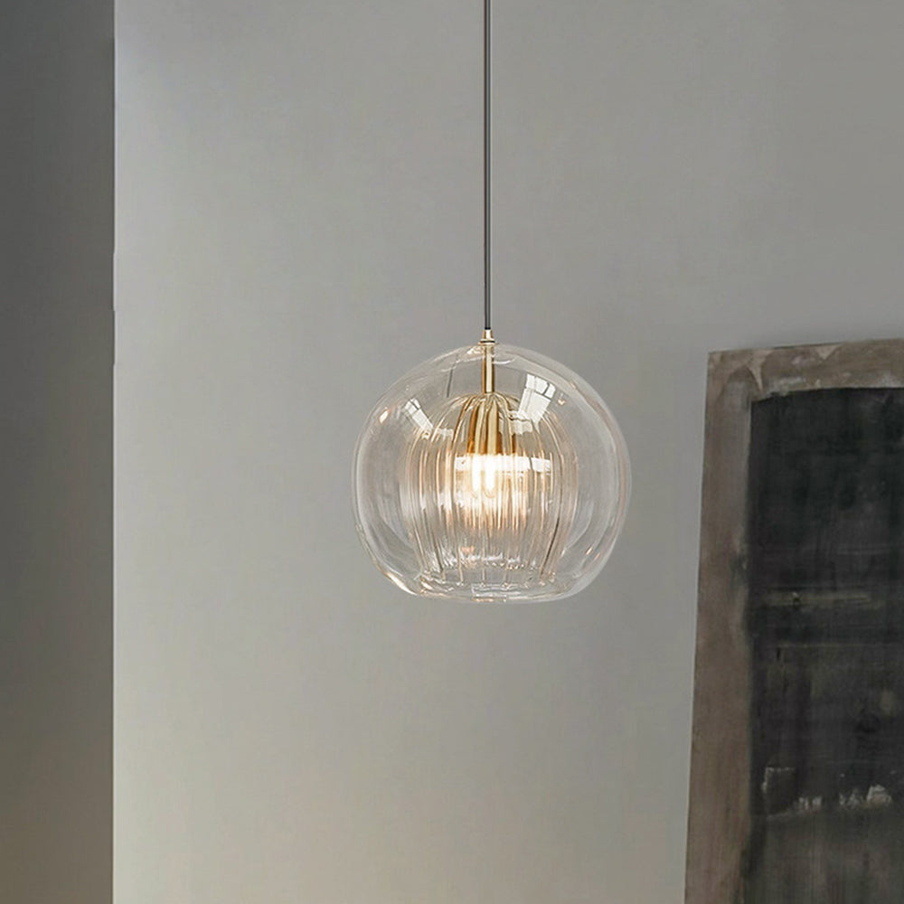 Modern clear double-layer glass globe tuoj pendant light with a ribbed inner shade suspended in a contemporary living space